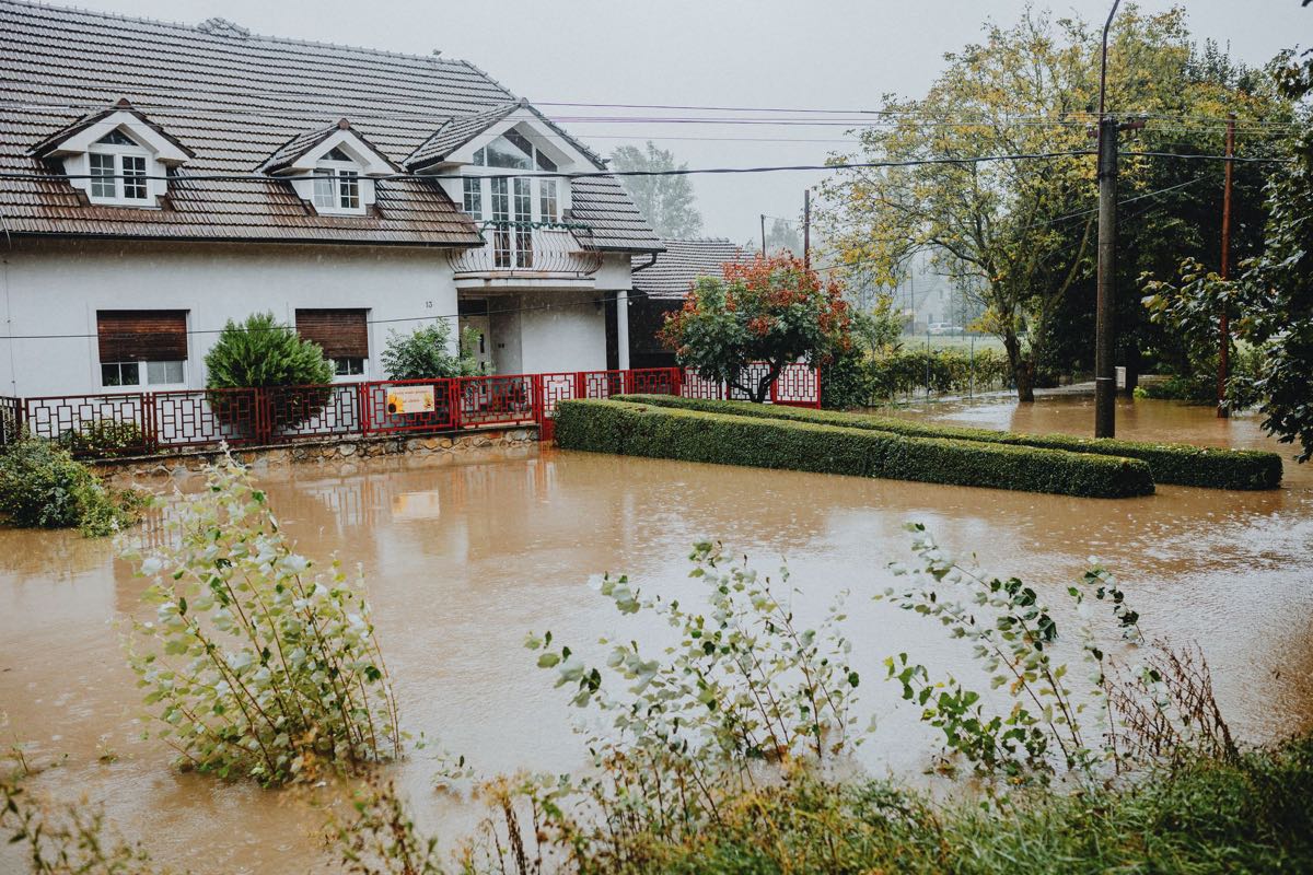 Suburban house with floodwater across the yard.
